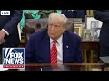 President Trump signs executive orders from the Oval Office