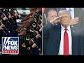 'Army Goes Rolling Along' as Trump salutes troops at military parade