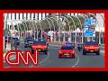 Trump welcomed to Qatar with red Cybertrucks and mounted camels